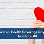 Hands holding a red heart with a medical cross in front of a white brick wall, symbolizing Universal Health Coverage Day and the message of health care for all.